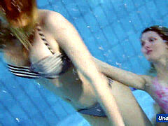 insane girls disrobe eachother in the pool