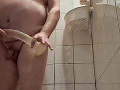 Transparent very long dildo in shower