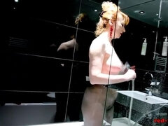 Redheaded Sluts Showers With Her Nylons On As She Rubs Her Twat