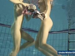 Horny girls strip eachother in the pool