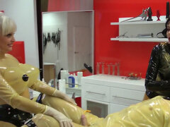 Gimp in latex bondage endures cock and balls punishment