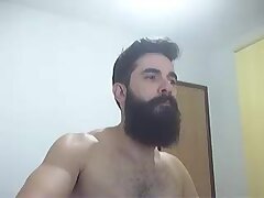 Bearded man stroking his cock