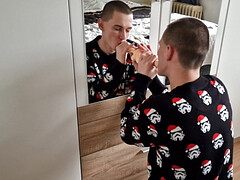 Naughty young horny daddy sucking big dildo in front of mirror dressed in Christmas sweater ...