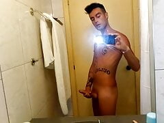 Tattooed young guy jerks off in hotel bathroom, cums in sink