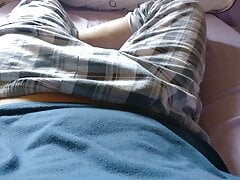 Twink cute boy tempts to show his dick under his plaid trousers pajama