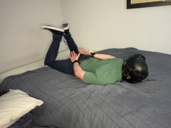 Selfbondage in a hogtie while hooded and Plugged