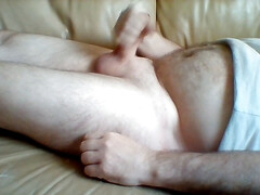 Lies on the couch and plays with my cock and jerks off until the juice comes.