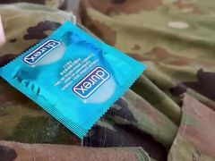 Jerking off in uniform into a condom already full of the cum of buddies
