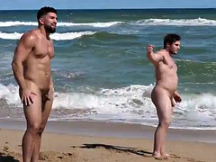Muscular males in natural attire on the beach