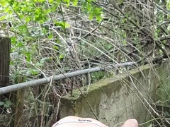 Guy in cutoffs and footwear undresses off and blows a load outdoors