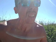 Muscled man public onanism at a well-liked park. People passing by...interrupting him! RISKY!!!