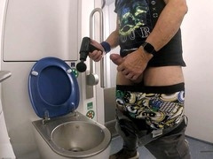 In a train bathroom, I use a wand on my huge member and let loose