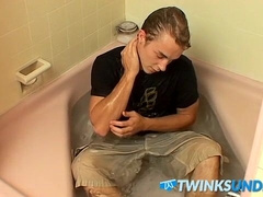 Muscular jock plays with his cock while taking nice bath