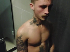 young fellow demonstrating off in the gym bathroom