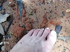 Pink painted toes on red wet dirt,the juxtaposition makes like not hurt. camera shaky cause balance comes in spurts love