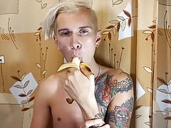 Sweet boy eats a banana greedily