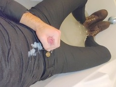 Horny guy in skinny jeans has a fun time jerking off in a fully clothed tub