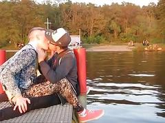 Loving boyfriends share a passionate kiss on a pier
