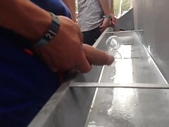 long heavy uncut cock pissing in public at trough urinal