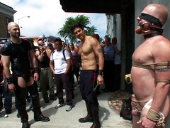 Nick Moretti in a public domination scene with Luke Riley