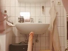 Tranny jerks off with a dildo in her ass in the bathtub