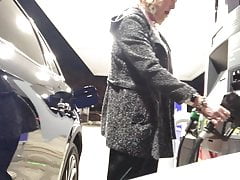 Cold night at the gas station in sexy midi-skirt and boots