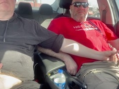 Jerking off our cocks in the car at a parking lot
