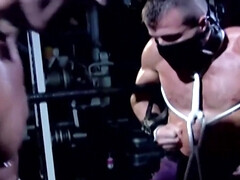 Muscular male slave is captive and set to endure merciless cock in ass