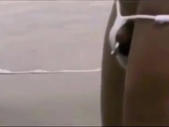 Asian bodybuilder barely covered at the beach