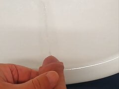 Master Ramon quickly pisses his golden juice in the sink