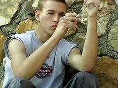 Skinny gay dude smoking outdoors before stripping and jerking off