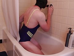 Sissy in swimsuit and latex plays with dildo