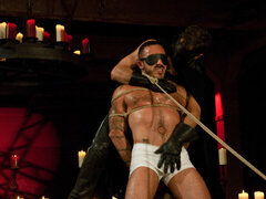 Leather daddy celebrating Halloween with the slave