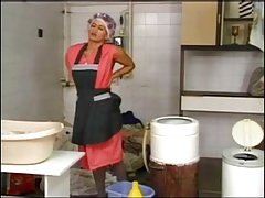 Laundering mature housewife in grey Pantyhose and curlers