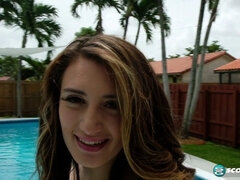 Britt James plays with her big tits by the pool in her bikini and scores some big boob play!