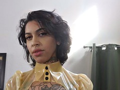 Femdom in latex, ebony with gloves fucks sub with strap-on