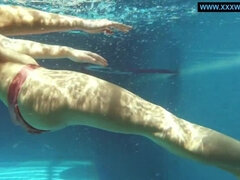 Kittina swims naked in the swimming pool