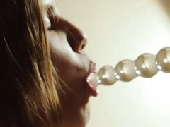 Muffling her screams with a ballgag as she sextoys her pussy