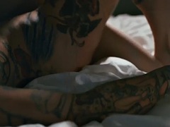Tattooed lesbian with a big ass passionately rubs pussies with a friend