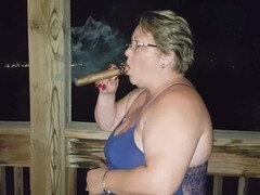 Smoking cigar fetish with a busty mature exhibitionist milf adorned in blue lingerie