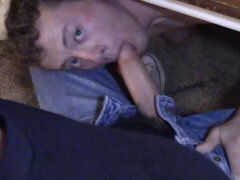 He is hiding below the table to give his partner a BJ