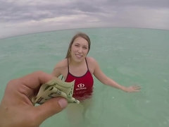 A top heavy woman is playing in the sea and in the bathroom