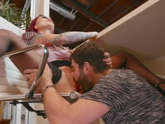 A bimbo with red hair is on the chair, getting licked and fucked