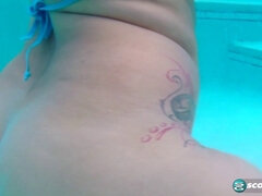 Cat Bangles rubs oil all over her big tits & tight pussy in the pool