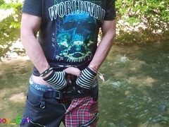 Guy in a creek urinates while jerking off his big cock