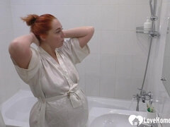 Pregnant Beauty Pleasures Herself in the Bathtub with a Round Belly