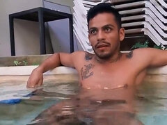 Tattooed Latino with a nice torso relaxing in the pool
