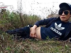 Cute gay Asian twink Jon Arteen speaks French wanks his smooth penis in the rain, lubricated with his saliva moans ejaculates