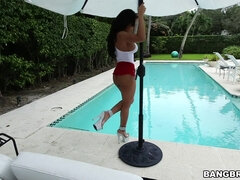 Luna Star in a tight shorts and high heels poses by the pool