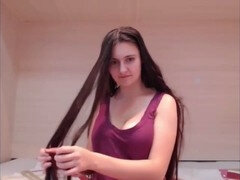 Long-haired beauty indulges in sensual hair play, striptease, and masturbation